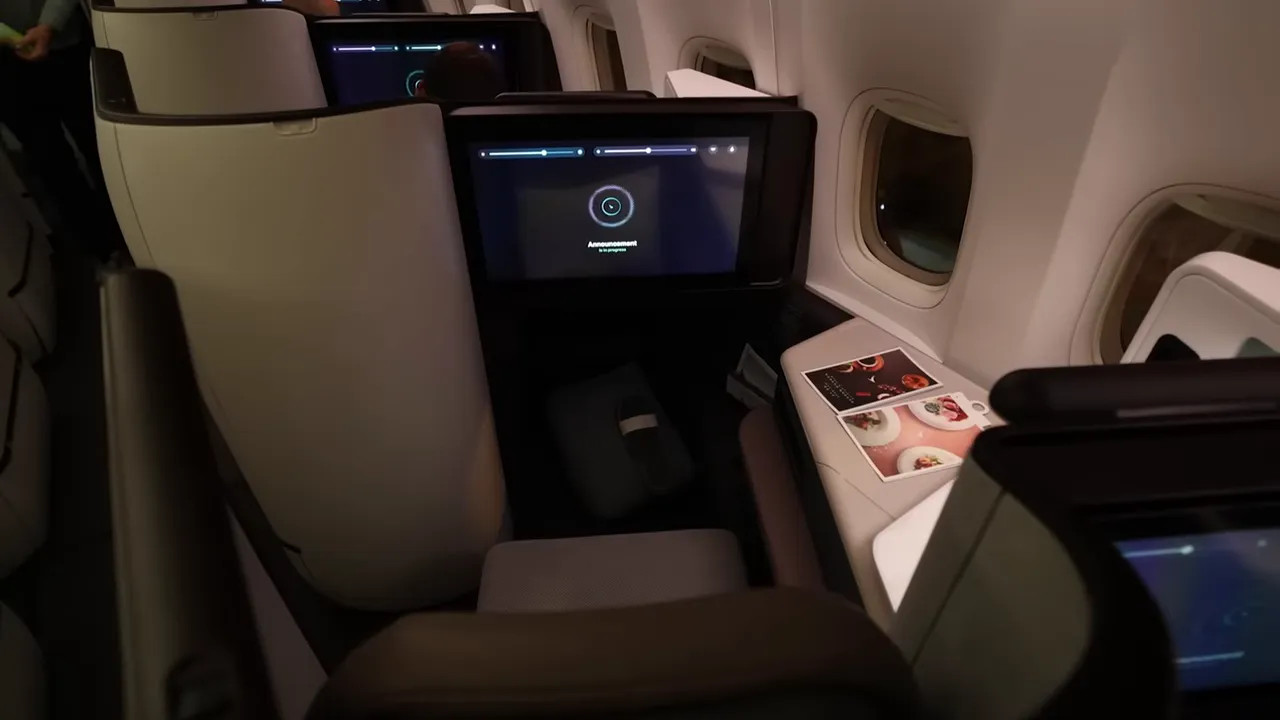 Cathay Aria Suite seat with large entertainment screen, window and side console visible