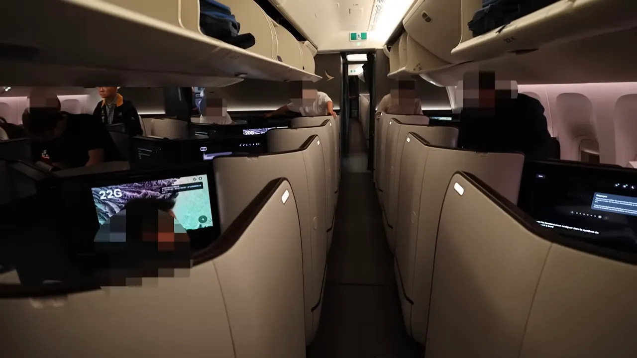 Cathay Pacific Aria Suite cabin interior showing staggered private business suites and large screens