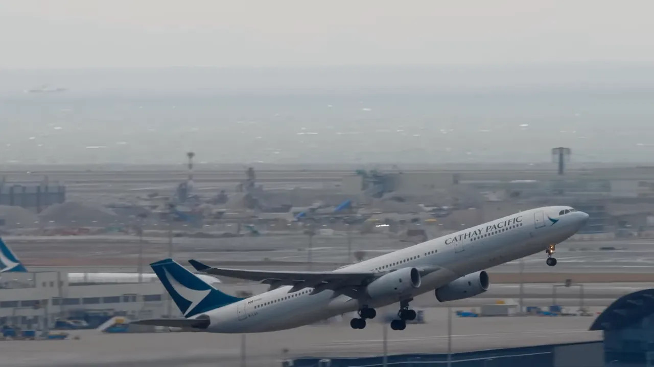 Cathay Pacific airplane taxiing at the airport with cloudy conditions during return to mainland China