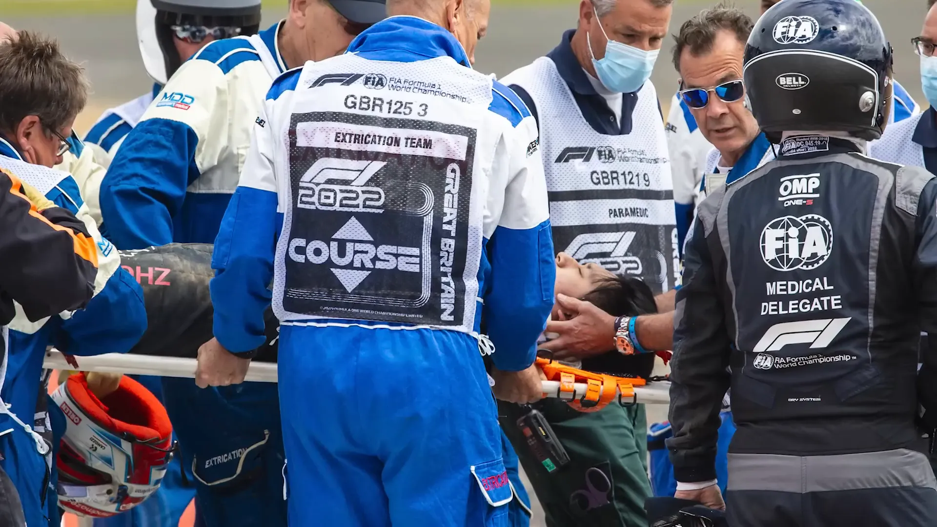 Zhou Guanyu on stretcher being carried off by medical team