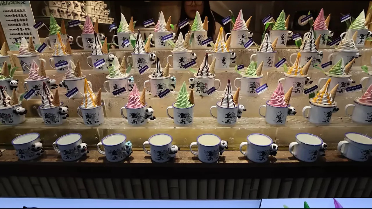 Assorted ice cream cones and desserts displayed on a Chongqing food street counter