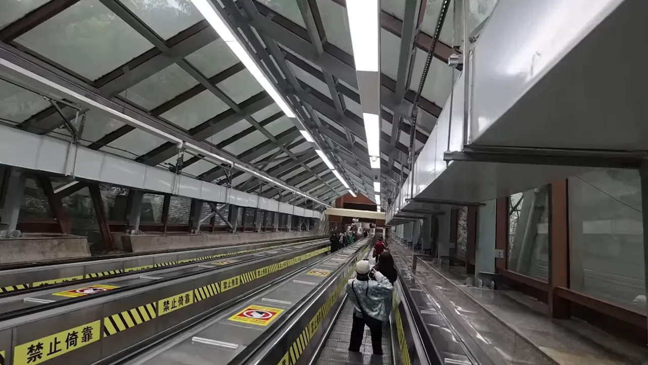 Chongqing subway escalator or station walkway inside an underground transit tunnel