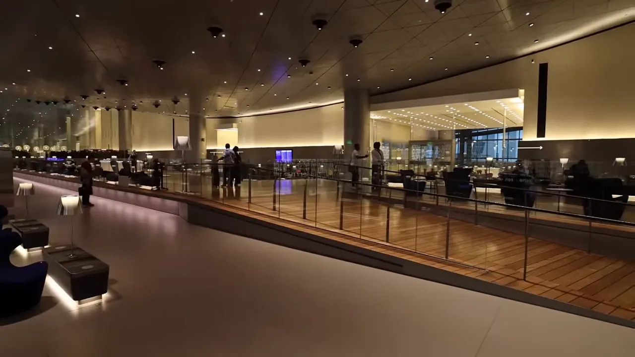 wide view of Hamad International lounge with high ceiling, seating and glass balustrade