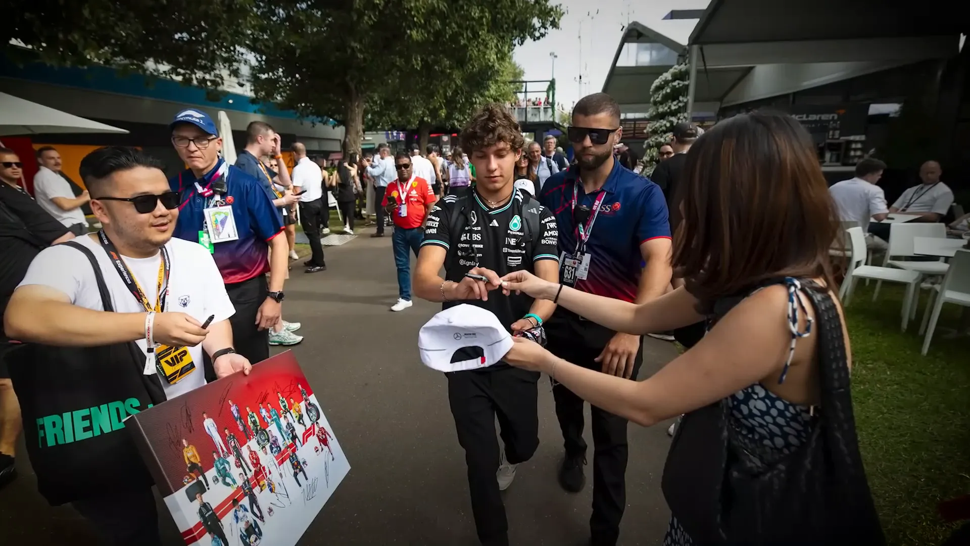 F1 driver surrounded by enthusiastic fans in Monza
