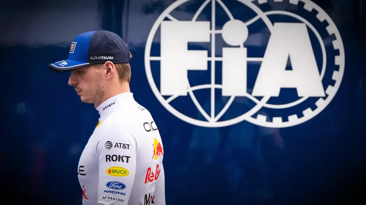 Driver standing in profile beside a large FIA logo on a blue backdrop