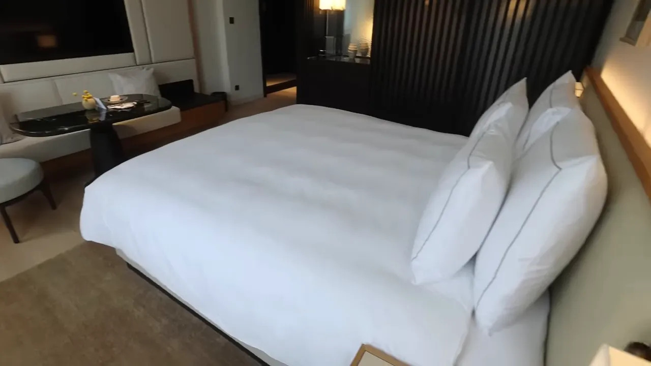 Hotel room bed with crisp white linens in Frankfurt