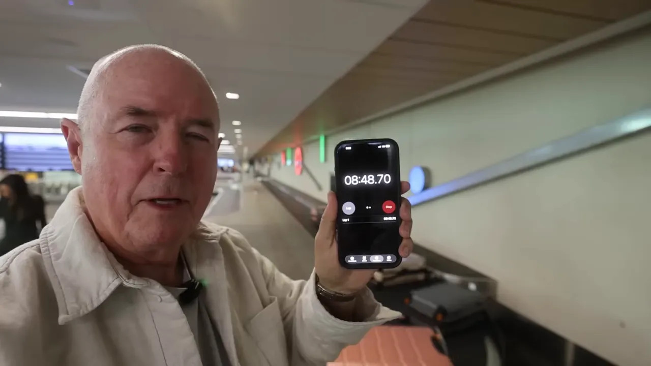 Timer held up beside the baggage carousel showing about 8 minutes 37 seconds