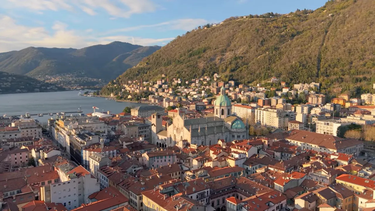 Aerial view of Como city and cathedral beside Lake Como at sunset