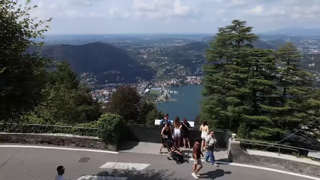 View down the steep funicular railway tracks toward Lake Como and the city