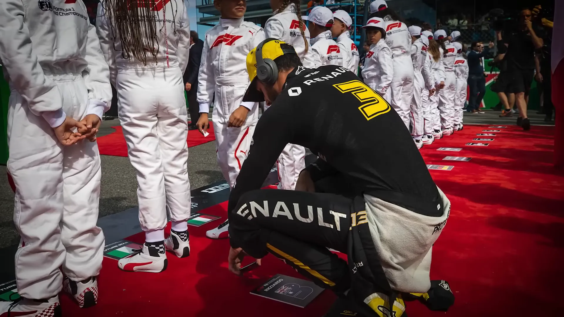 Drivers rushing to their positions for the national anthem before the race start