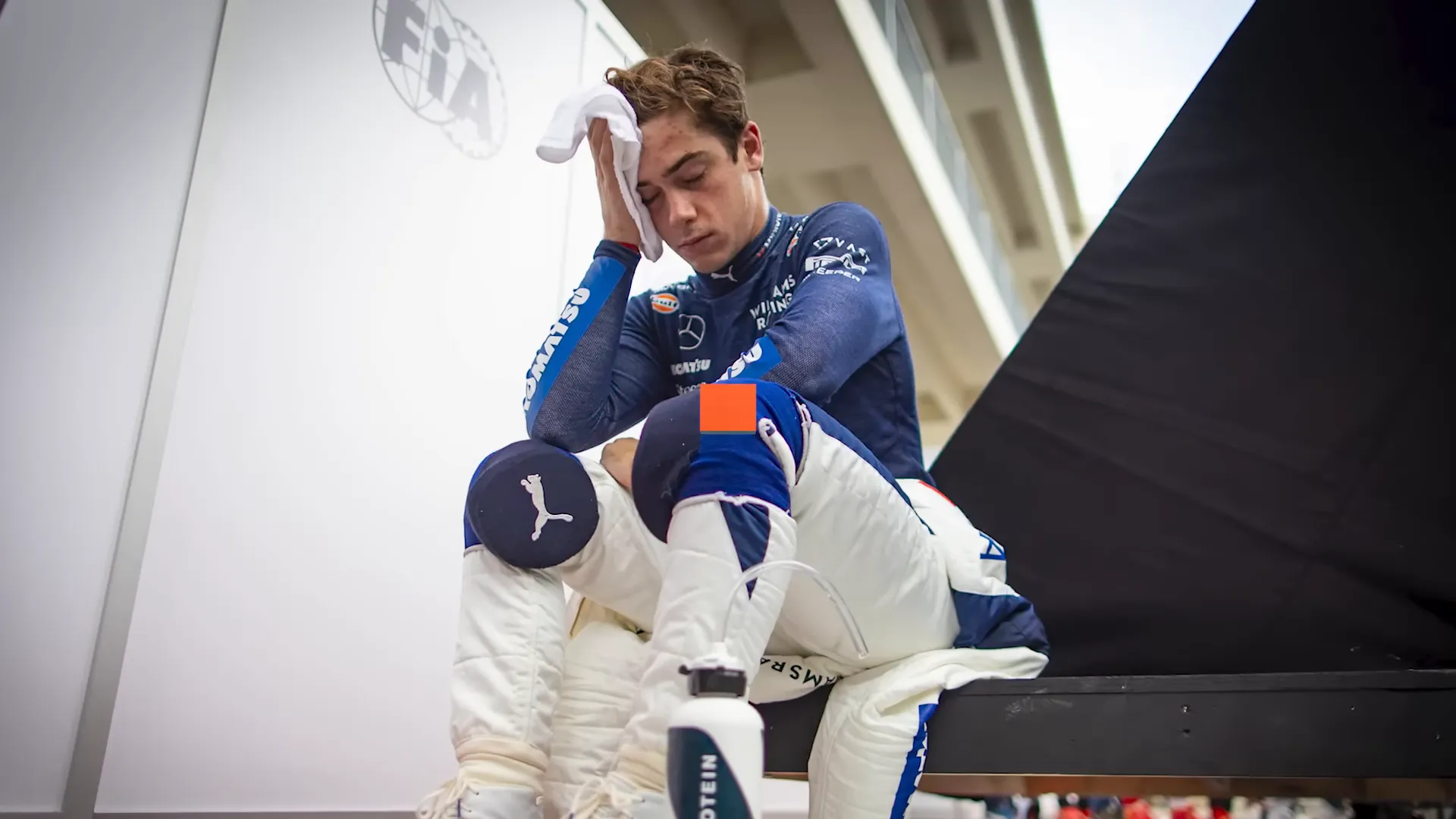 Franco Colapinto sitting in the press pen catching his breath after the race