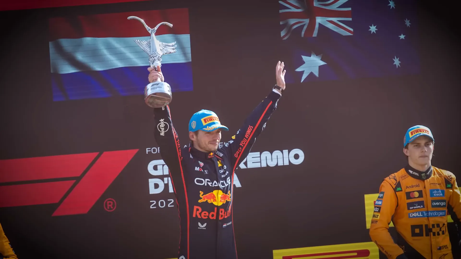 Max Verstappen celebrating while watching the McLaren exchange unfold on track