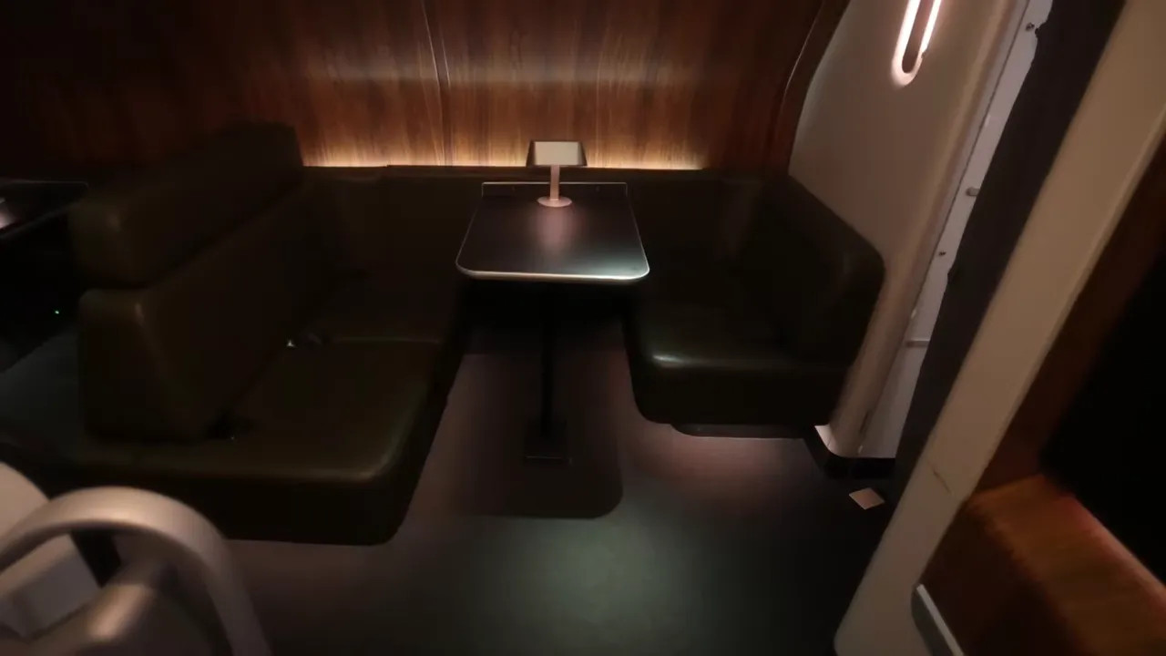 Qantas A380 First Class onboard lounge seating area at night