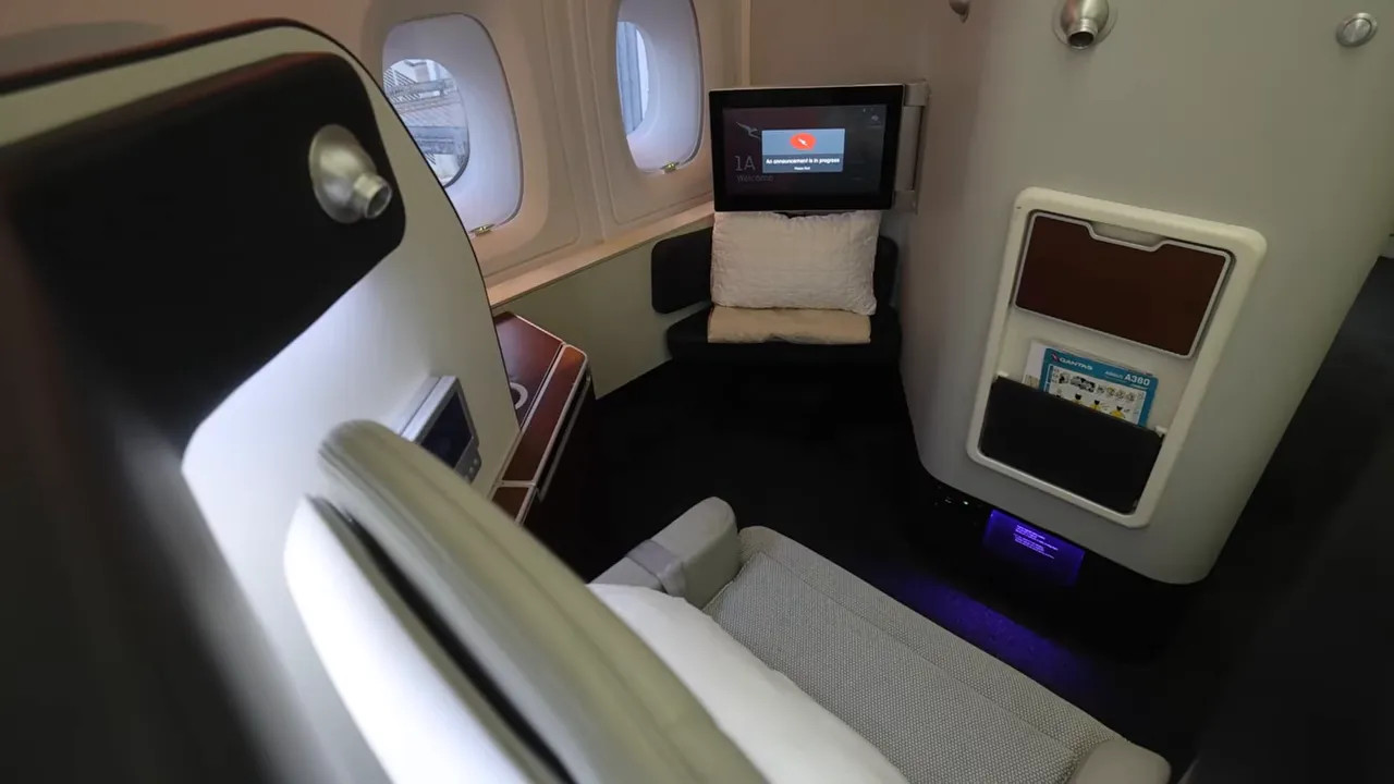 Qantas A380 First Class suite bed viewed from above with onboard control panels
