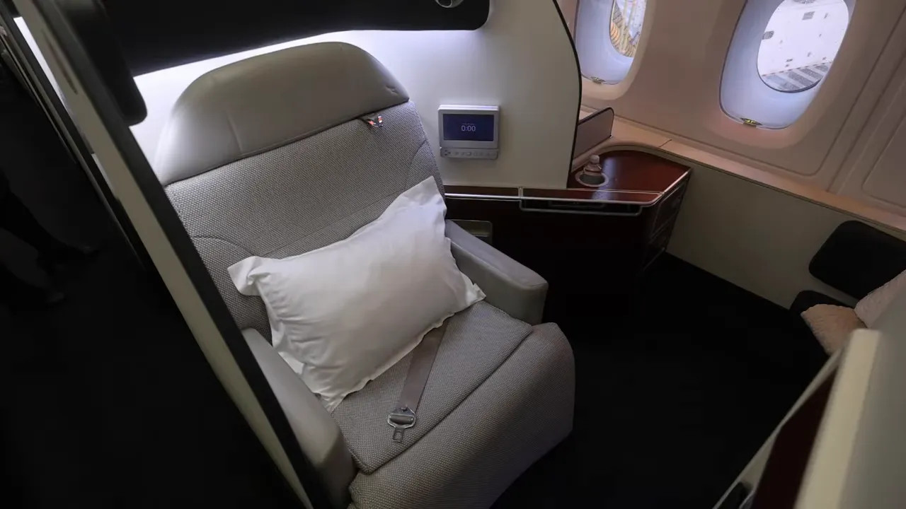 Qantas A380 First Class suite seat with headrest and storage panel