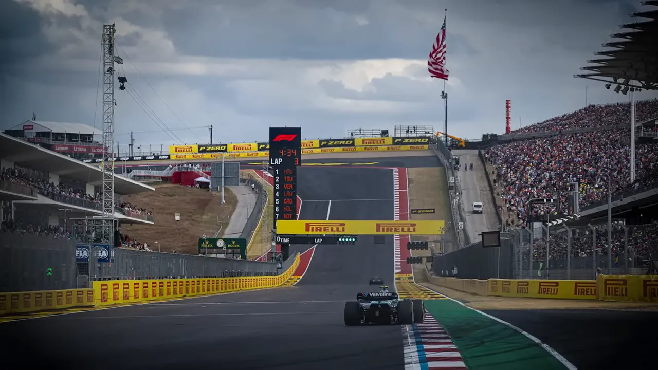 Fans packed on the hill at Turn 1 watching cars crest the climb