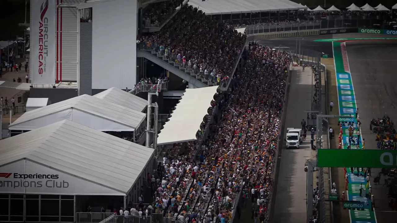 Fans watching action from a wide grandstand at Circuit of the Americas