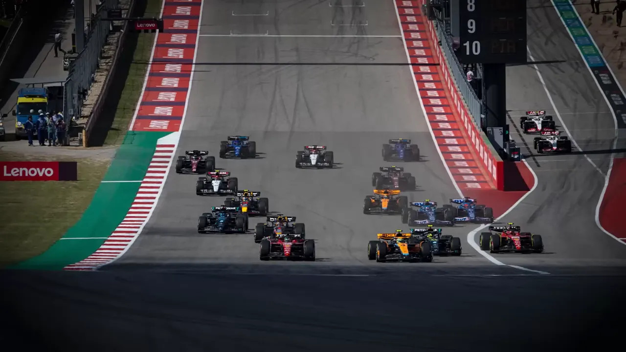 McLaren cars on track with fans watching from the grandstands