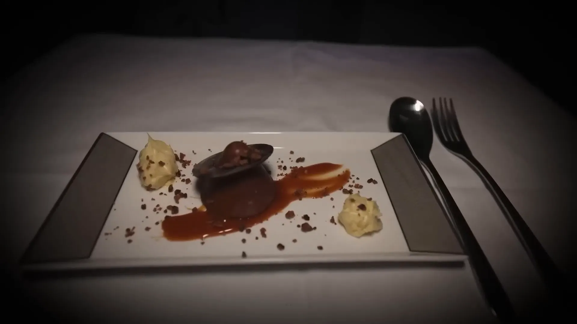 Dessert presentation: a malted chocolate cylinder and cheese