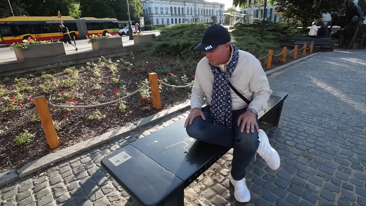 black stone musical bench with a hand pressing a button