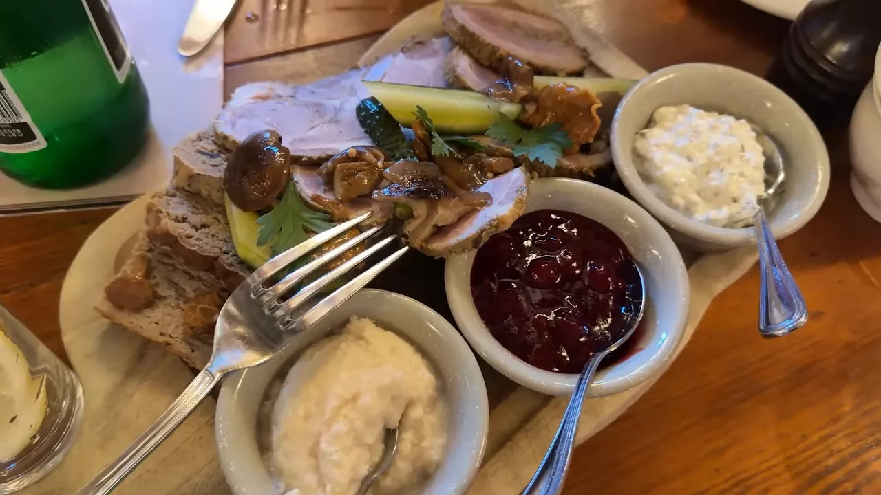 large plate with roasted half chicken and sausage