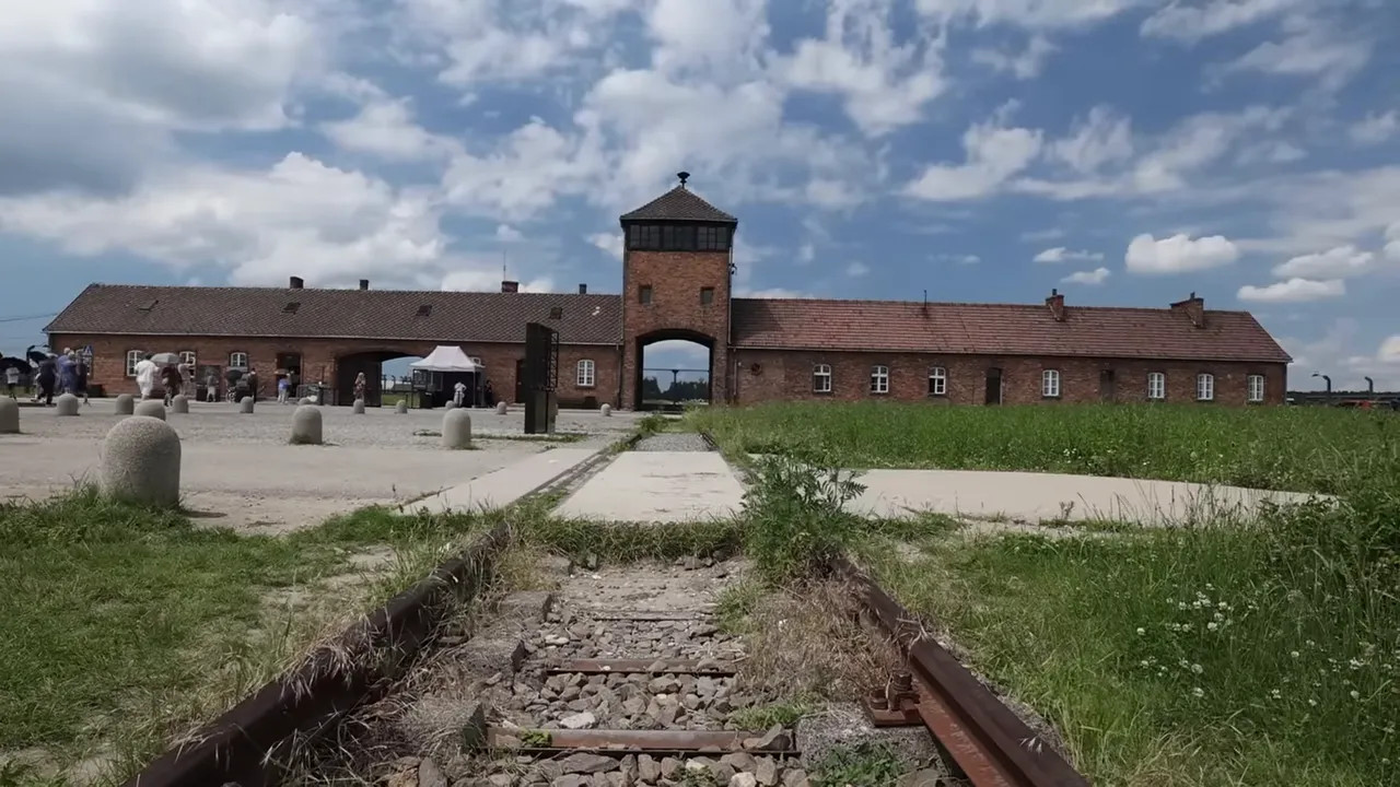 rail track leading to the brick gatehouse at Birkenau