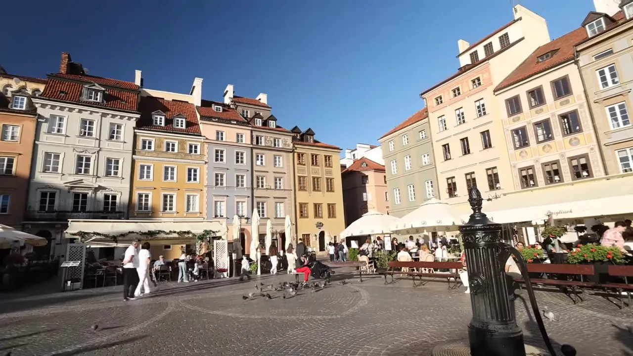 Warsaw Old Town Market Square with pastel buildings and restaurant terraces