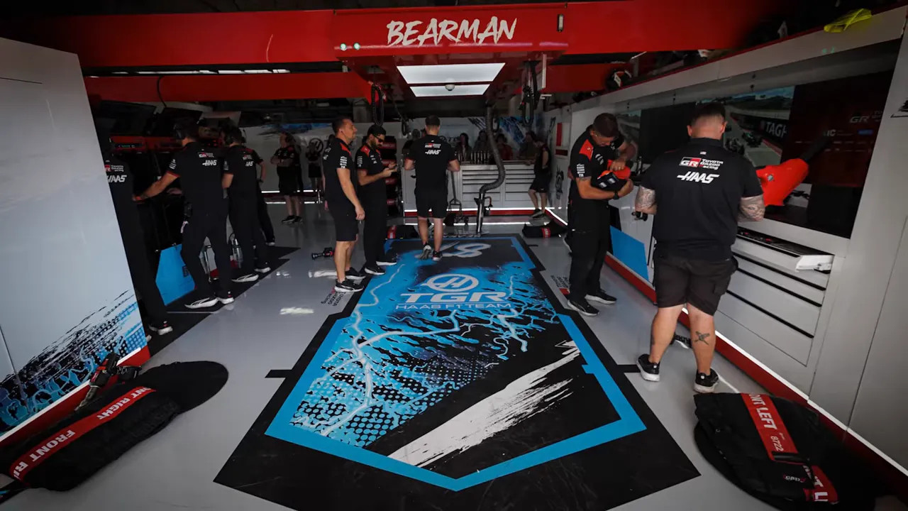 Haas garage with a large blue-and-black graphic across the floor