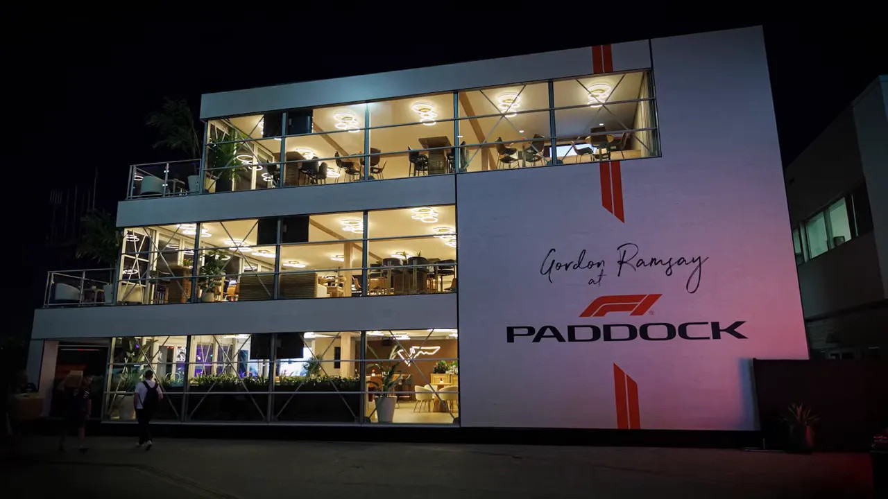 Illuminated Gordon Ramsay F1 Paddock hospitality building at night