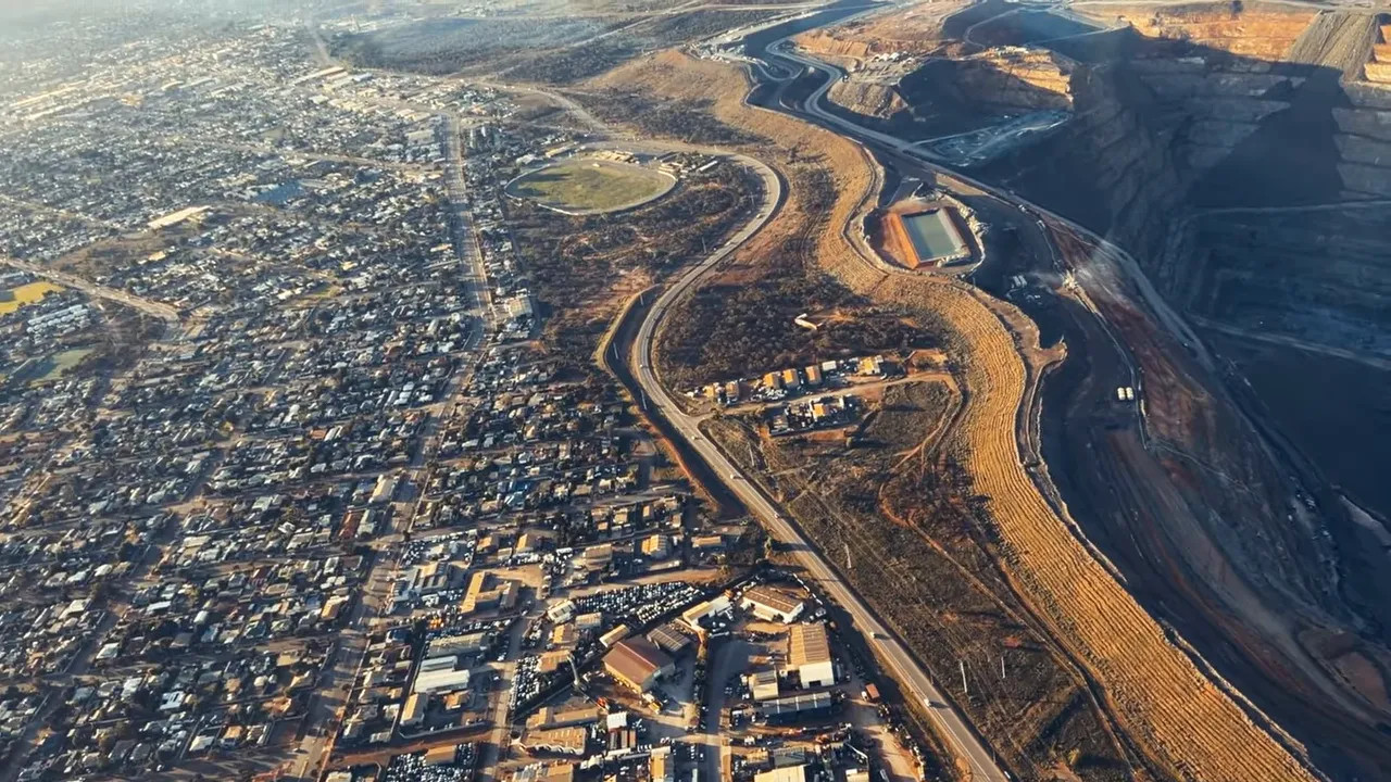 Aerial view showing Kalgoorlie homes beside the massive Super Pit