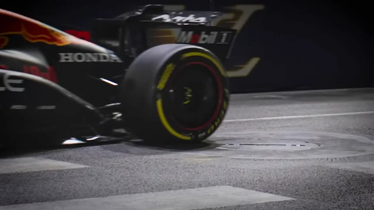 F1 tyre passing adjacent to a manhole cover on the street circuit, illustrating proximity and potential uplift