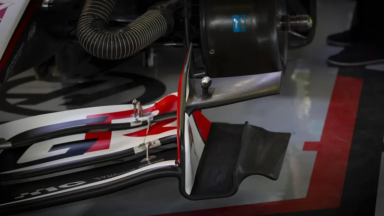 Close-up of a Formula car front wing showing multiple flaps, outboard endplate and small fin elements