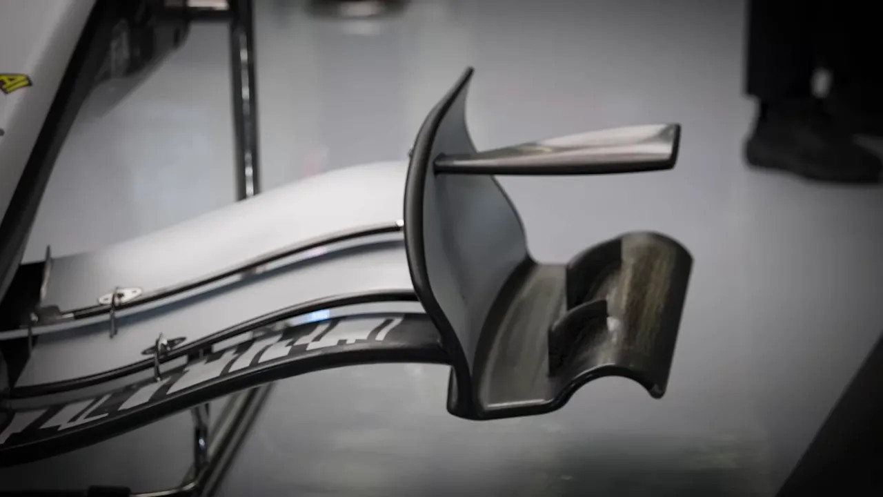 Close-up of an F1 front wing outer element showing multiple flaps and endplate detail