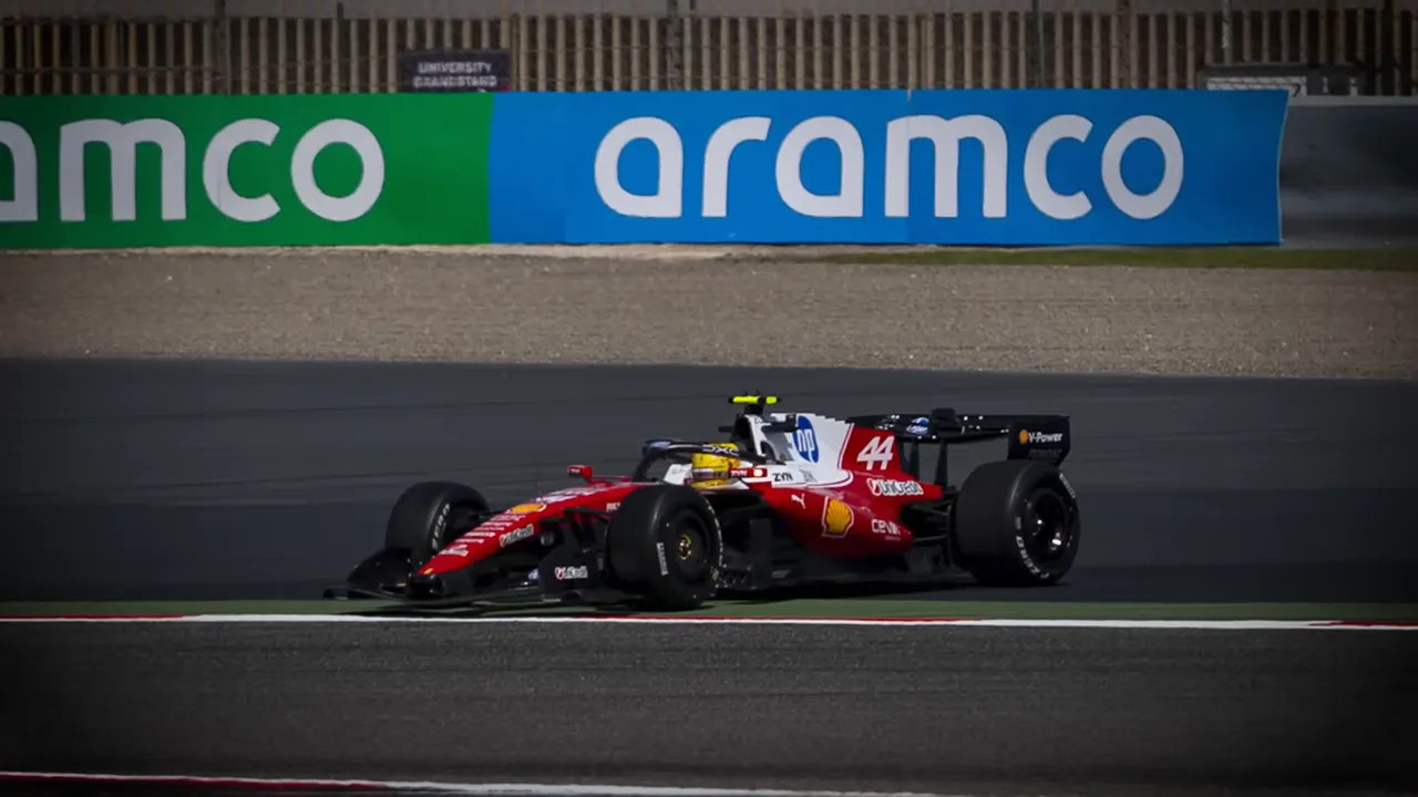 Red Formula 1 car (No. 44) cornering on track with Aramco hoarding in the background.