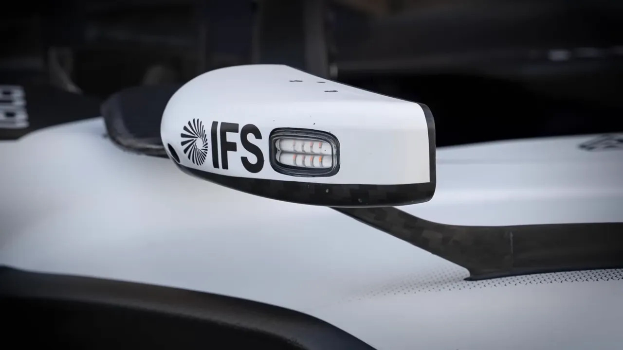 Side mirror pod with integrated LED lights and IFS logo on a race car