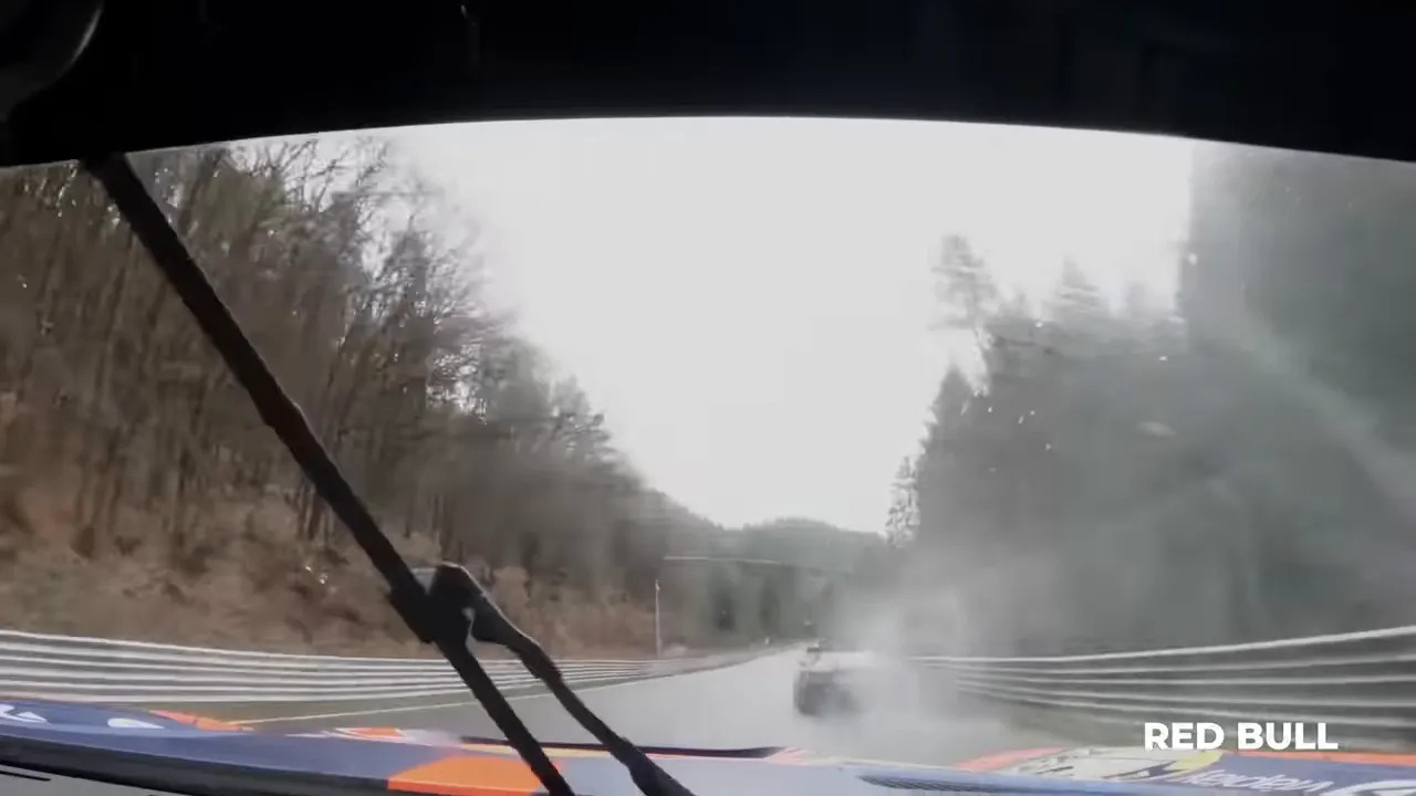 Onboard view from inside a race car driving on the foggy Nürburgring circuit