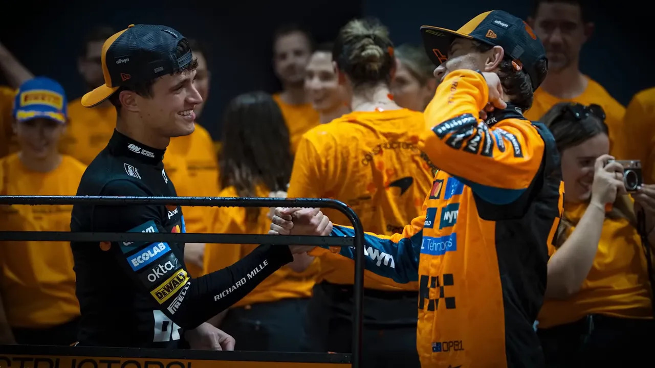 McLaren team celebration in pit lane with Oscar and Lando present and composed