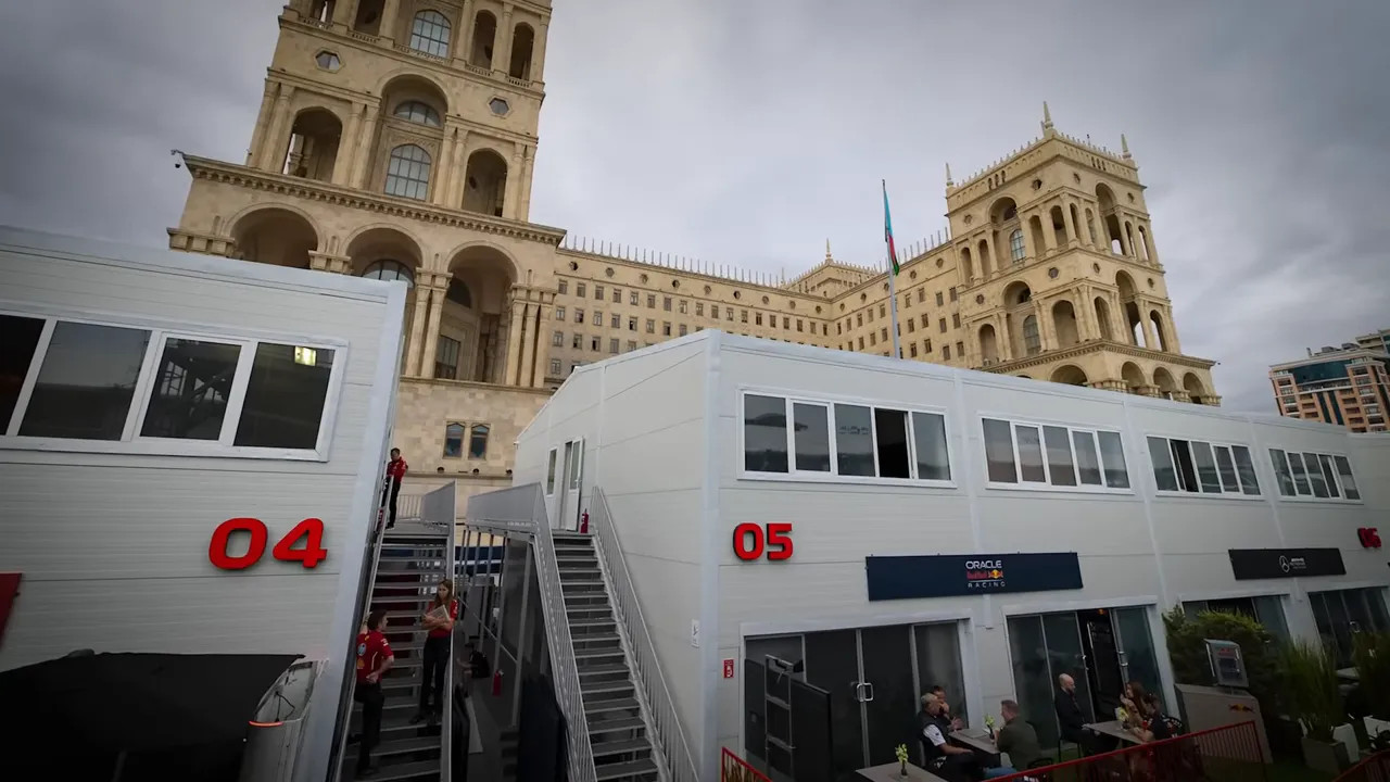 Lewis Hamilton escorted behind the hospitality suites to avoid media