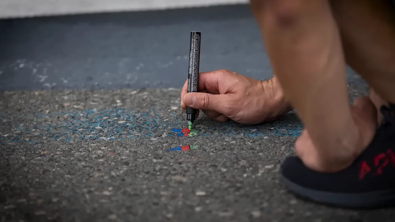 Ollie working on race-specific art in front of the Red Bull garage