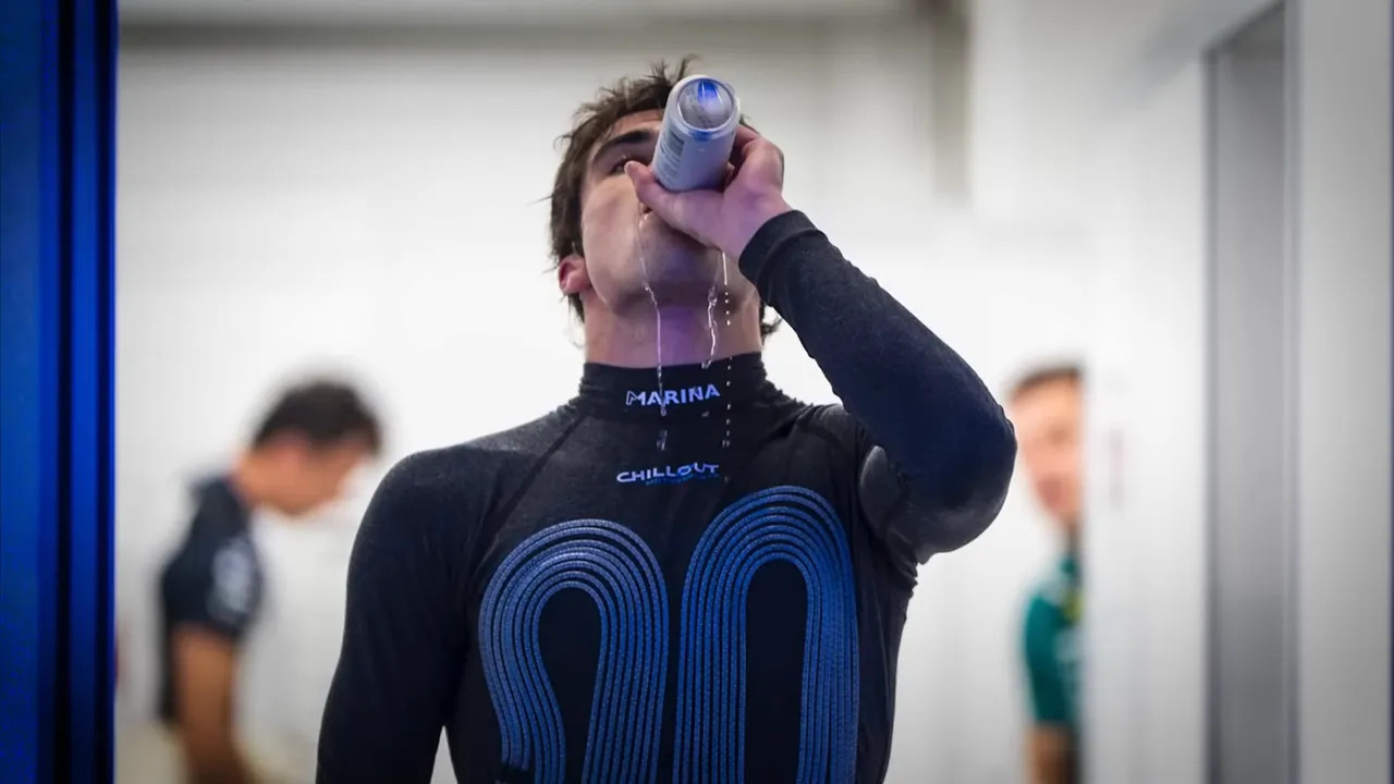 Racing driver drinking from a bottle with liquid spilling, showing effort to rehydrate