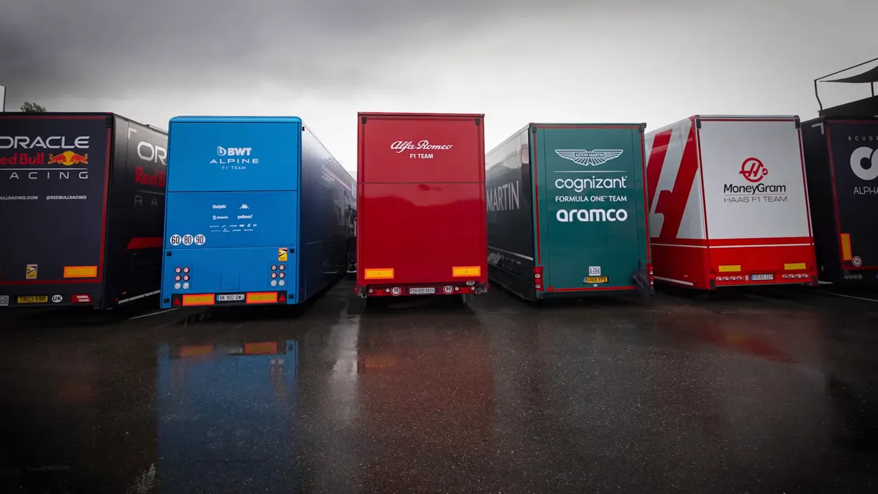 Row of Formula 1 team transporters and trailers parked side by side