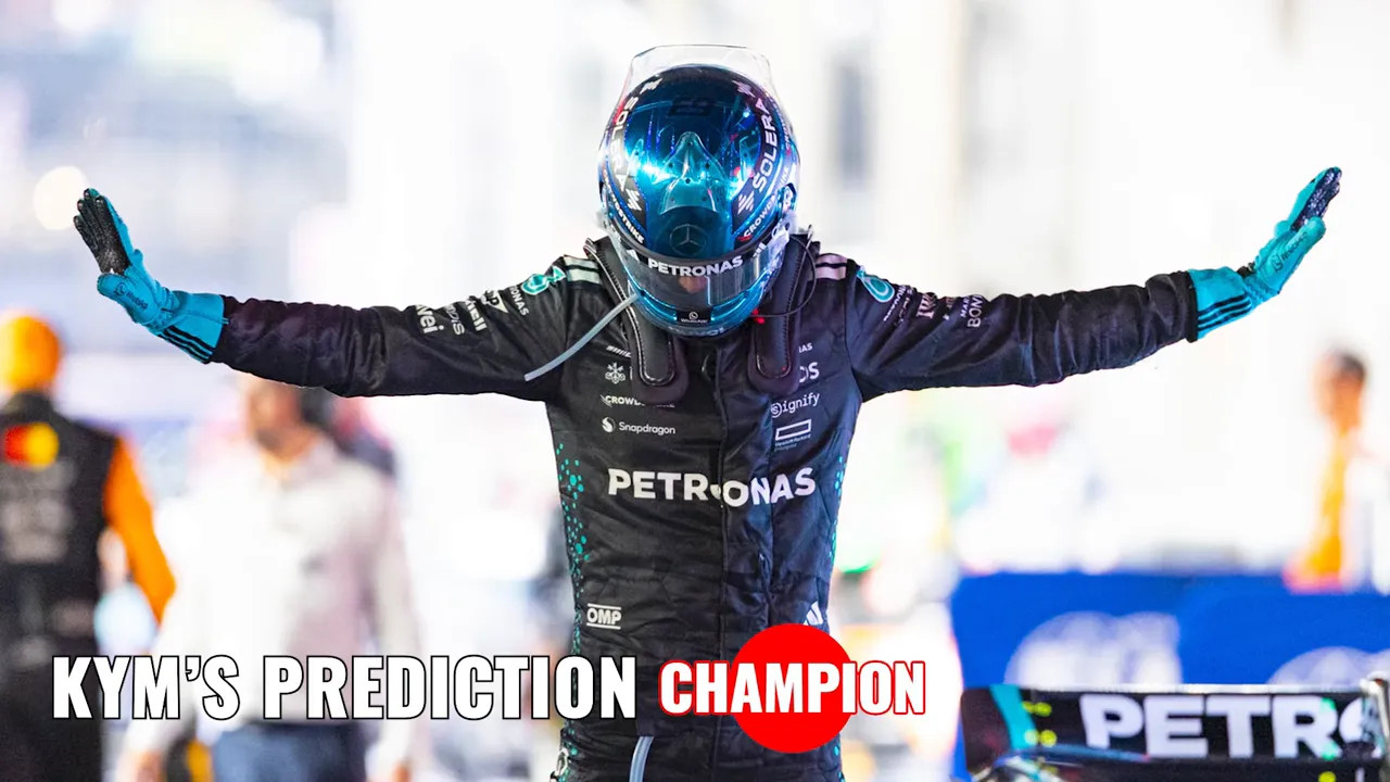 Race driver in a Petronas suit with arms outstretched, headline text overlay reading 'Prediction Champion'.
