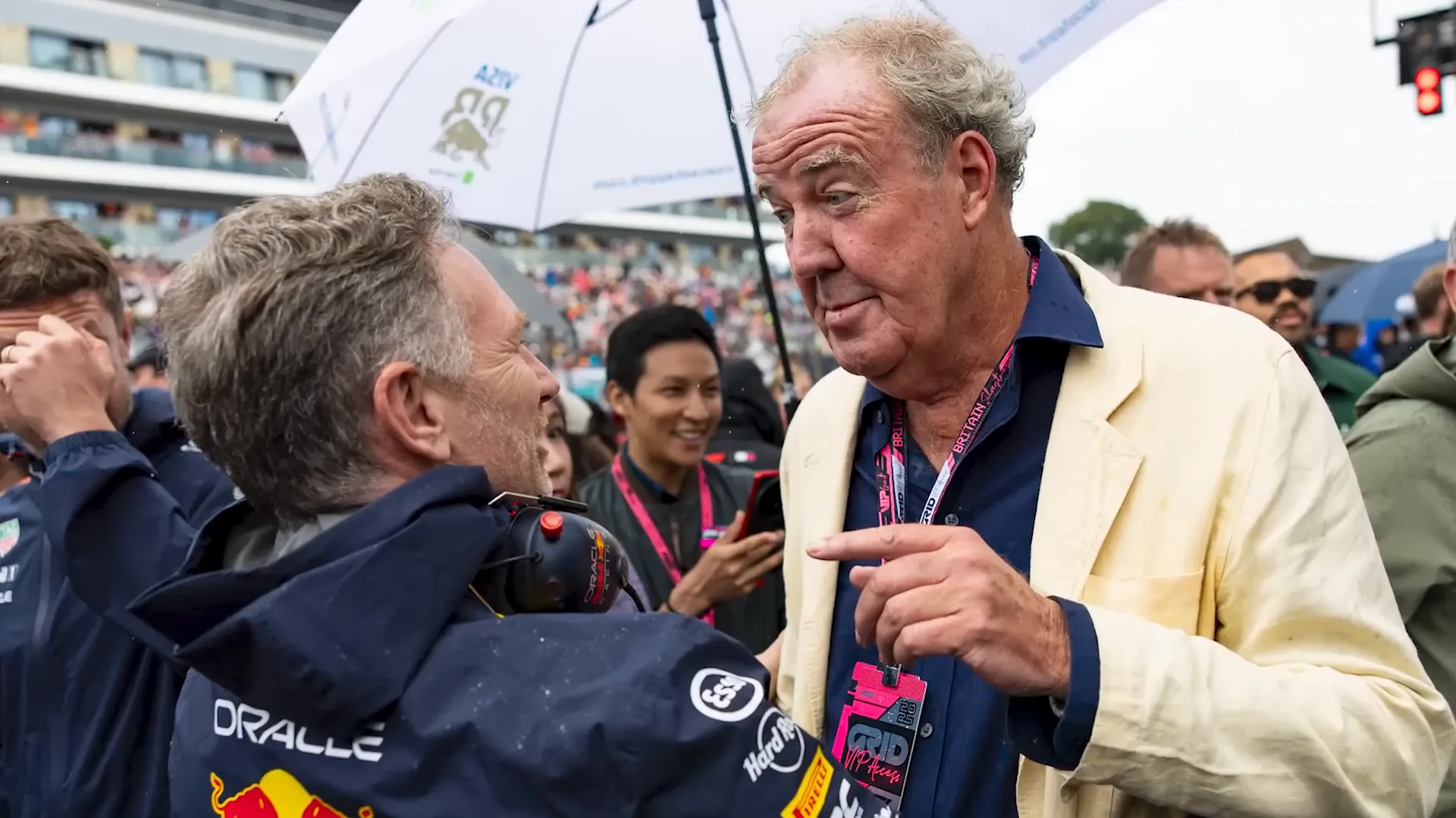 Jeremy Clarkson arriving on the grid with McLaren communications manager Mark Norris