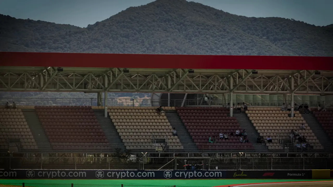 Grandstand with many empty seats and a mountain in the background
