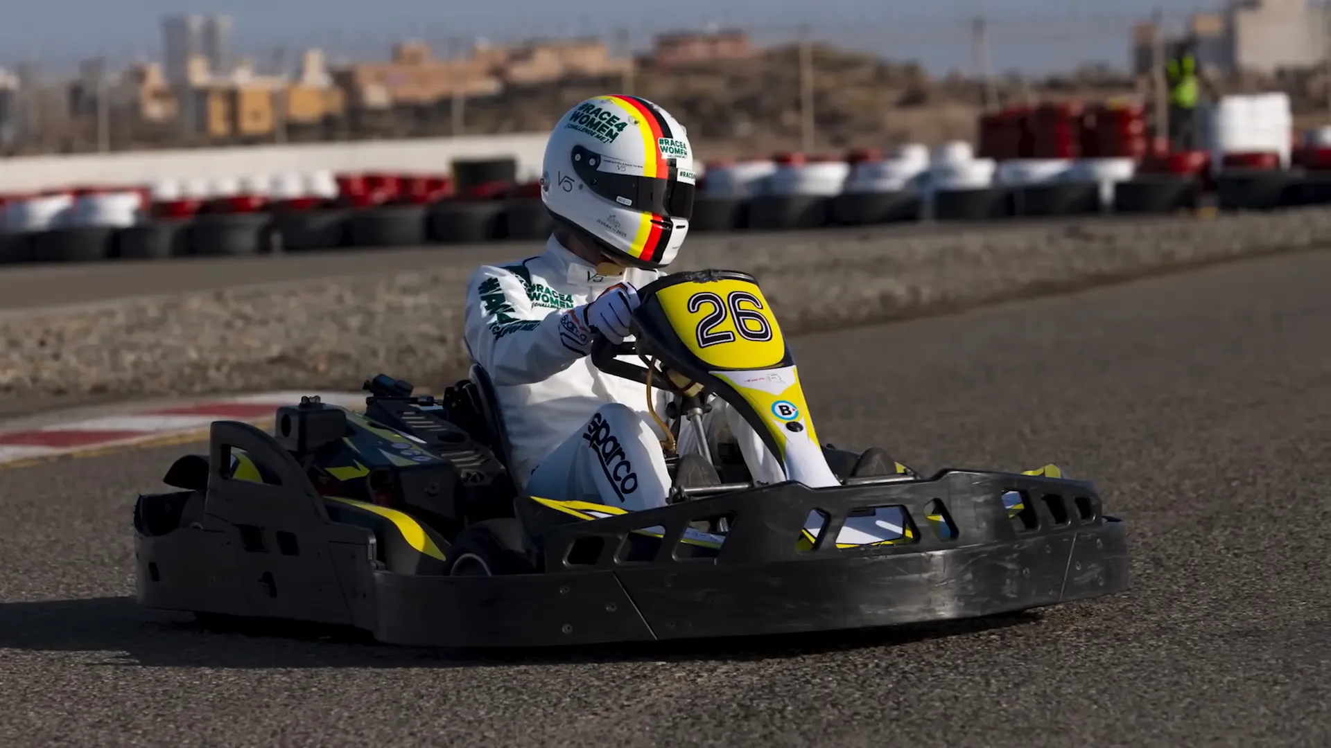 Sebastian Vettel driving alongside young racers