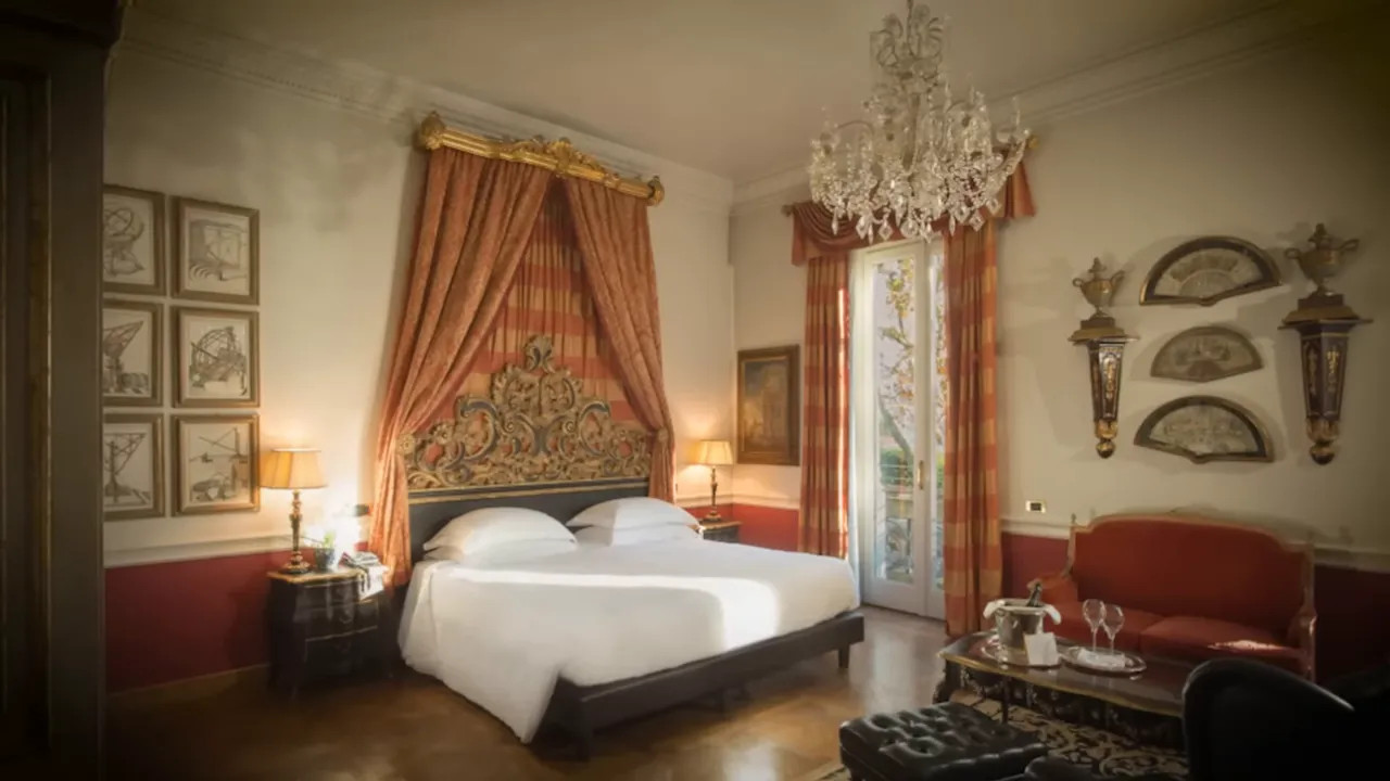 Luxury hotel bedroom with bed, curtains, and chandelier