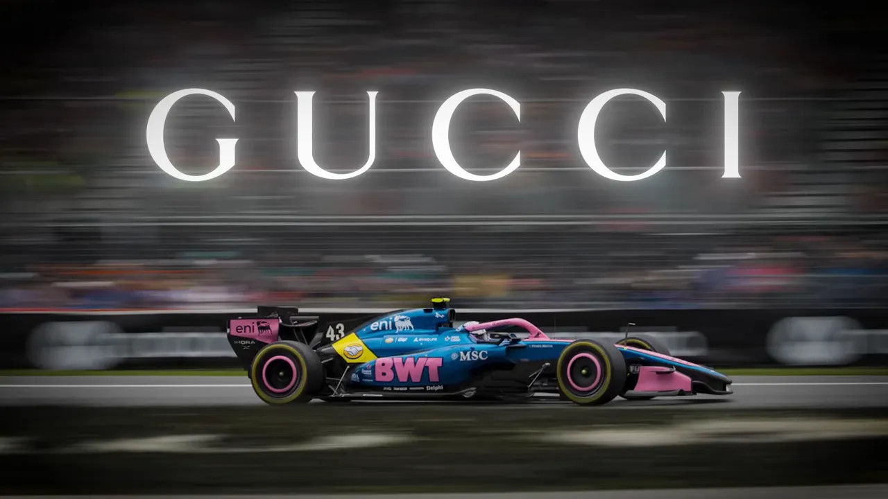 Alpine Formula 1 car with large Gucci text in the background