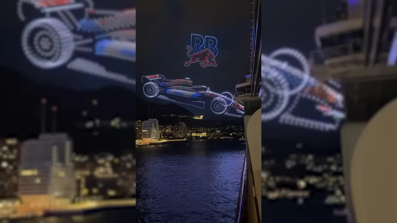 Night drone display over the harbour showing a Formula 1 car outline and Red Bull text