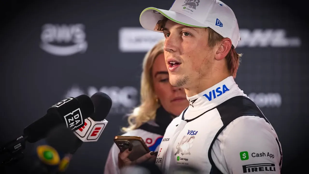 Driver speaking to multiple microphones (DAZN, ESPN) while a reporter holds a phone in the media pen