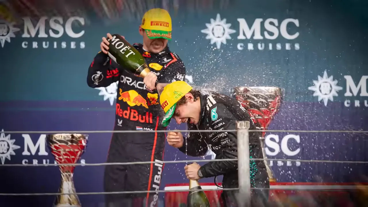 F1 drivers spraying champagne on the podium in celebration